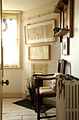 Wooden armchair and radiator with artwork in Brighton home, UK