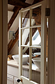 View through glass door to double basins in West Sussex home, England, UK