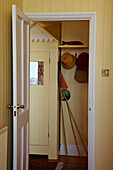 View through doorway to fishing nets in hallway of Cromer beach house, Norfolk, England, UK