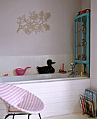 Traditional bathroom with white panelling and pink plastic woven chair