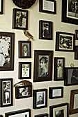Collection of family photographs displayed on wall