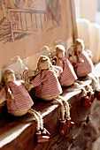 A detail of a country style bedroom handmade doll figures