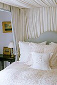 Four poster bed in traditional country style bedroom