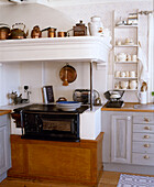 Traditionally Scandinavian stove in kitchen next to fitted unit