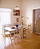 Wooden table and chairs laid for after0on tea