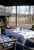 Detail of wooden furniture set outside a wooden summerhouse