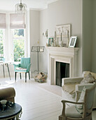 Green chair next to fireplace in room in neutral colours