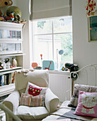 Childs room with armchair next to bed