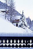 Exterior of snow covered Swiss chalets in mountains