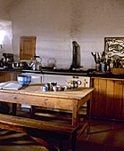 Country style kitchen with wood table and bench seats