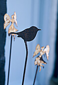 A detail of a cut out decoration of a bird figure