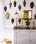 Collection of wooden ducks displayed on wall above wooden cabinet