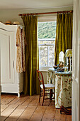 Dressing table and chair at bedroom window in Port Issac beach house Cornwall