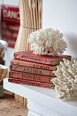 White coral with red hardbacked books in Shoreham by Sea, West Sussex, UK