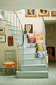 Cushions on staircase in Cotswold home of textile designer, UK