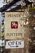 Magnolia blossom and shop sign for the Prindl Pottery in Cornwall, UK