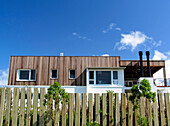 Holiday home exterior with fence and wood cladding
