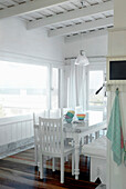 White painted dining room with wooden floor