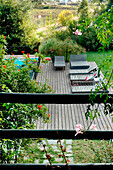 Sun loungers on poolside decking