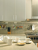 White fitted kitchen with china crockery