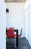 Pink chairs at dining table in white minimalist room