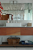 Bathroom mirror reflecting exposed stone wall