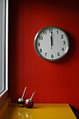 Kitchen clock on red feature wall