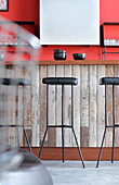 Recycled kitchen counter with Lapacho top and cast iron stools with black leather seats