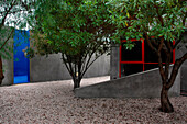Garden patio with gravel trees and a view of the swimming pool area in blue
