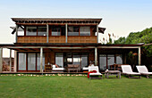 Coastal house exterior with grass lawn