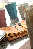 Brightly coloured tableware on marble worktop