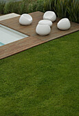 Futuristic outdoor seating deck with manicured lawn
