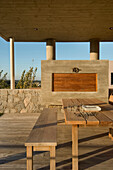 Concrete grill on decked terrace of beach house exterior