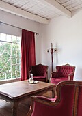 Armchairs and table by window in house, Carmelo, Uruguay