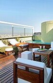 Sun loungers next to swimming pool on roof garden, Buenos Aires, Argentina