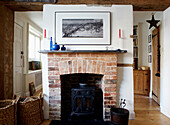 Exposed brickwork fireplace and structural beam in 1820s English home