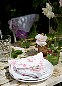 Plate with napkins on English country garden table