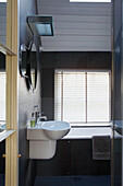 Black tiled bathroom of 1820s Georgian townhouse conversion