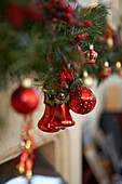 Red baubles and bells on Christmas tree