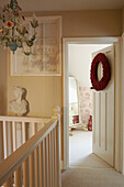 Christmas wreath on bedroom doorway opening from staircase landing 