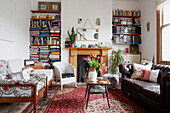 Recessed bookcases in living room with second hand sofa and armchairs