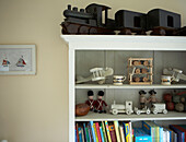 Wooden toys on shelving unit with books