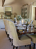 Slip covered dining room chairs at wooden dining table