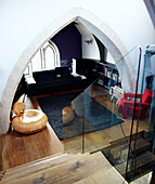 Living room through arched detail of school church conversion in Richmond
