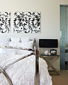 Metal framed bed with black and white artwork
