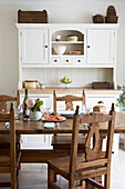 White fitted sunlit kitchen with freestanding work unit