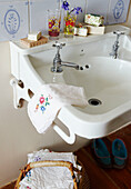 Metal taps on washbasin in Devon cottage bathroom