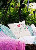Personalised cushions on daybed in garden