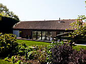 Barn conversion with open doors to back garden