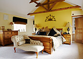 Patchwork quilt on bed of modern country house conversion